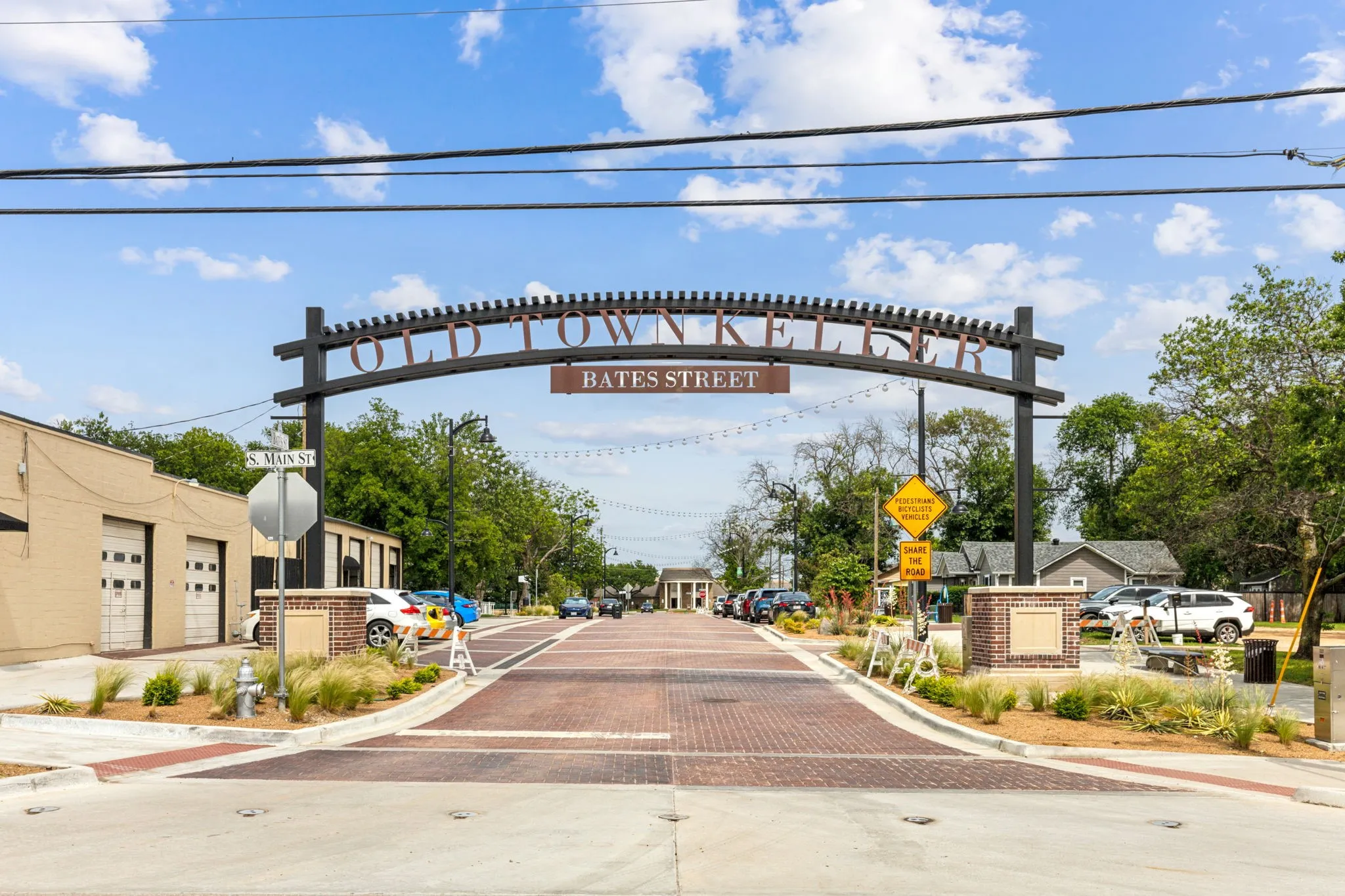 View of decorative road with traffic signs, curbs, and sidewalks