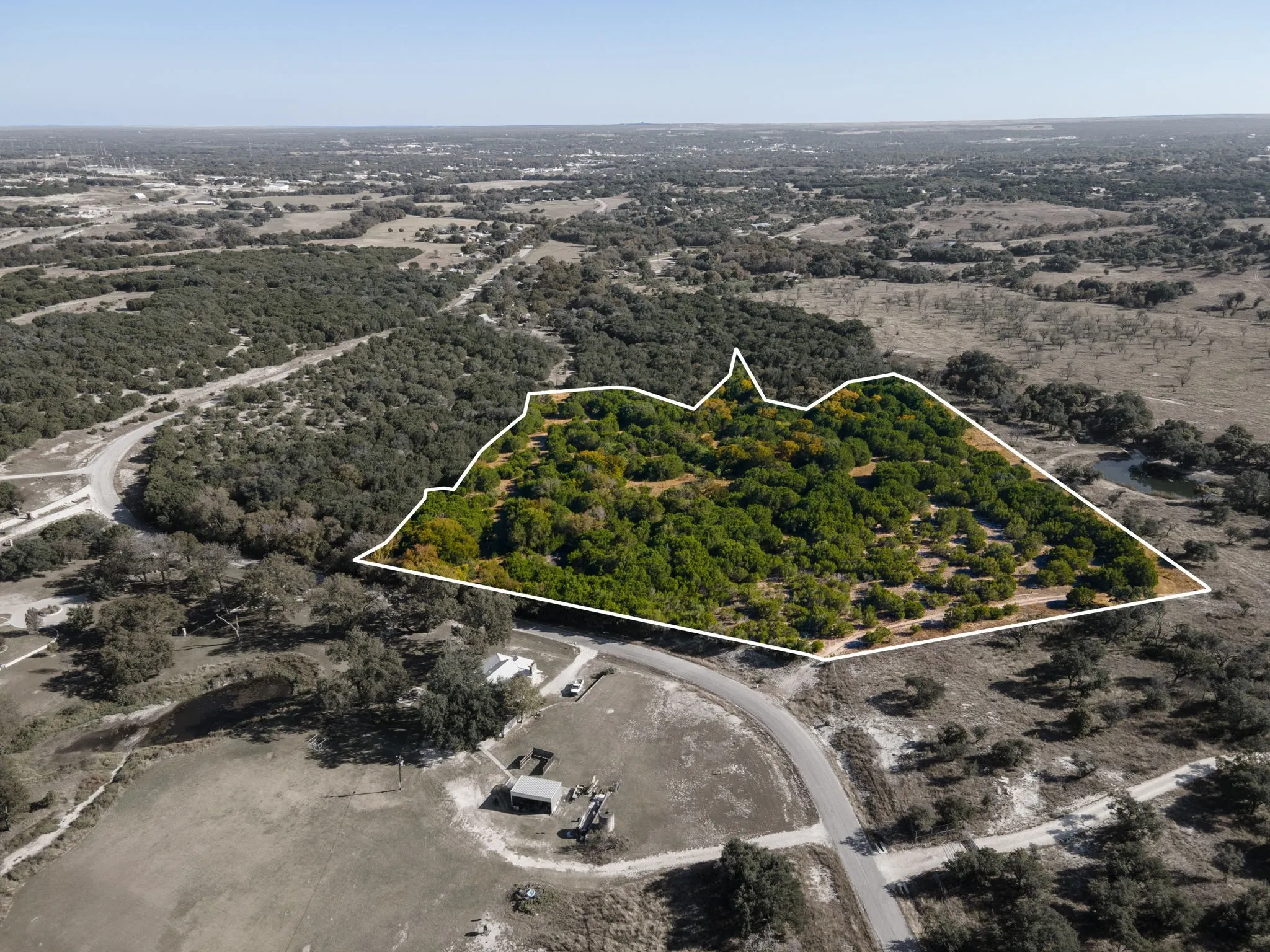 Aerial view of property's location with a forest and property boundaries highlighted