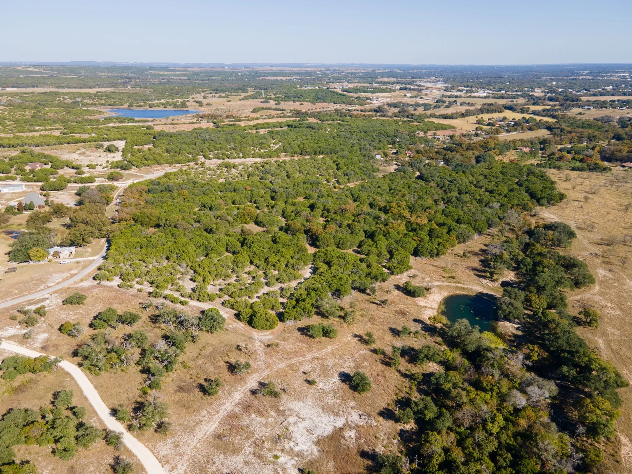 Aerial overview of property's location with a nearby body of water