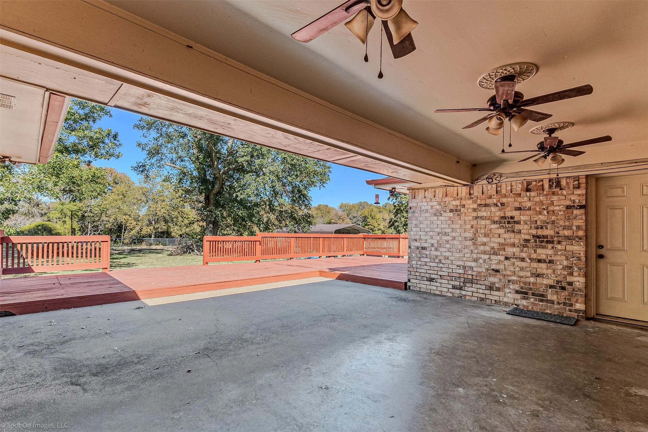 View of patio with a wooden deck and a ceiling fan