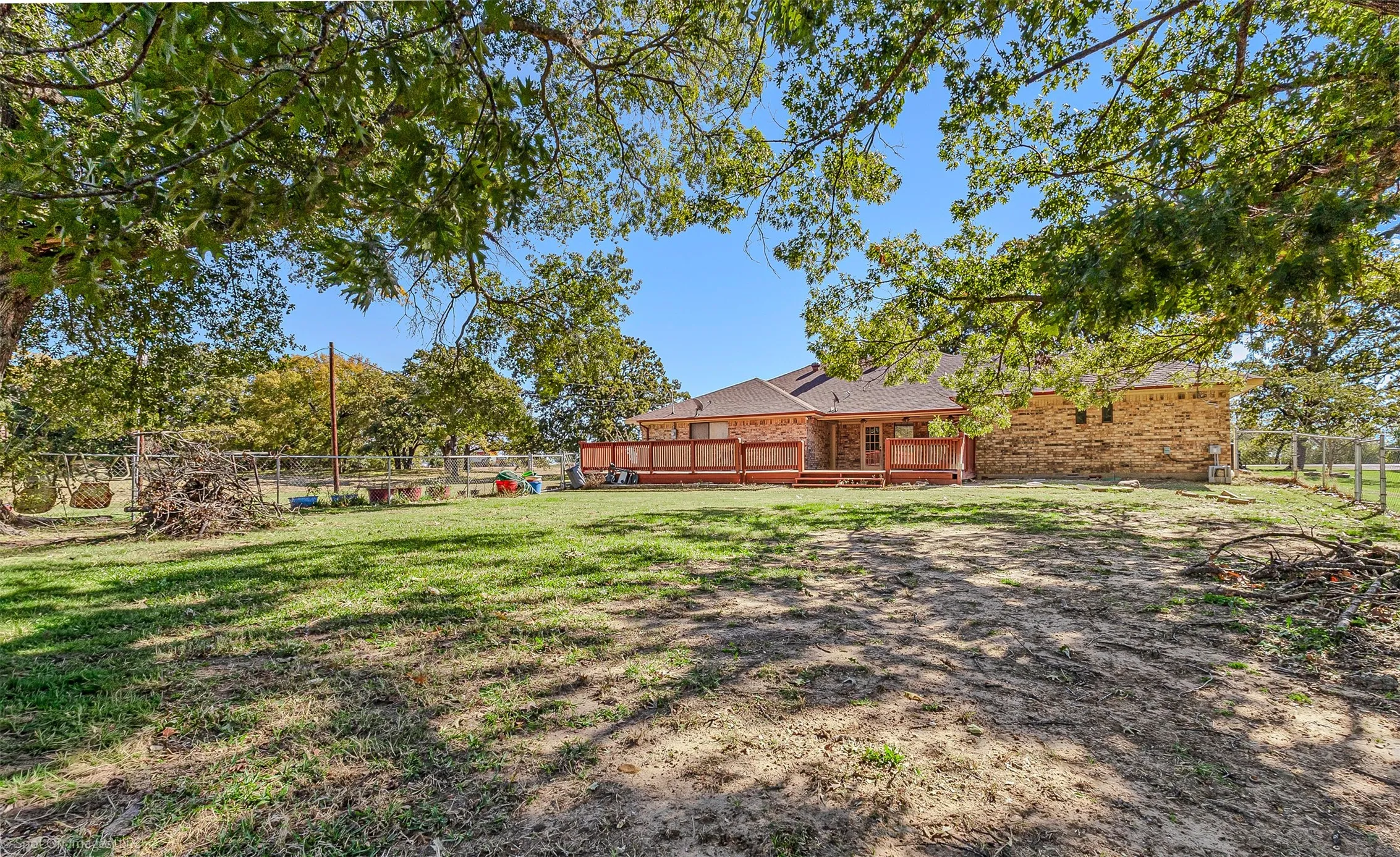 Fenced backyard with a deck