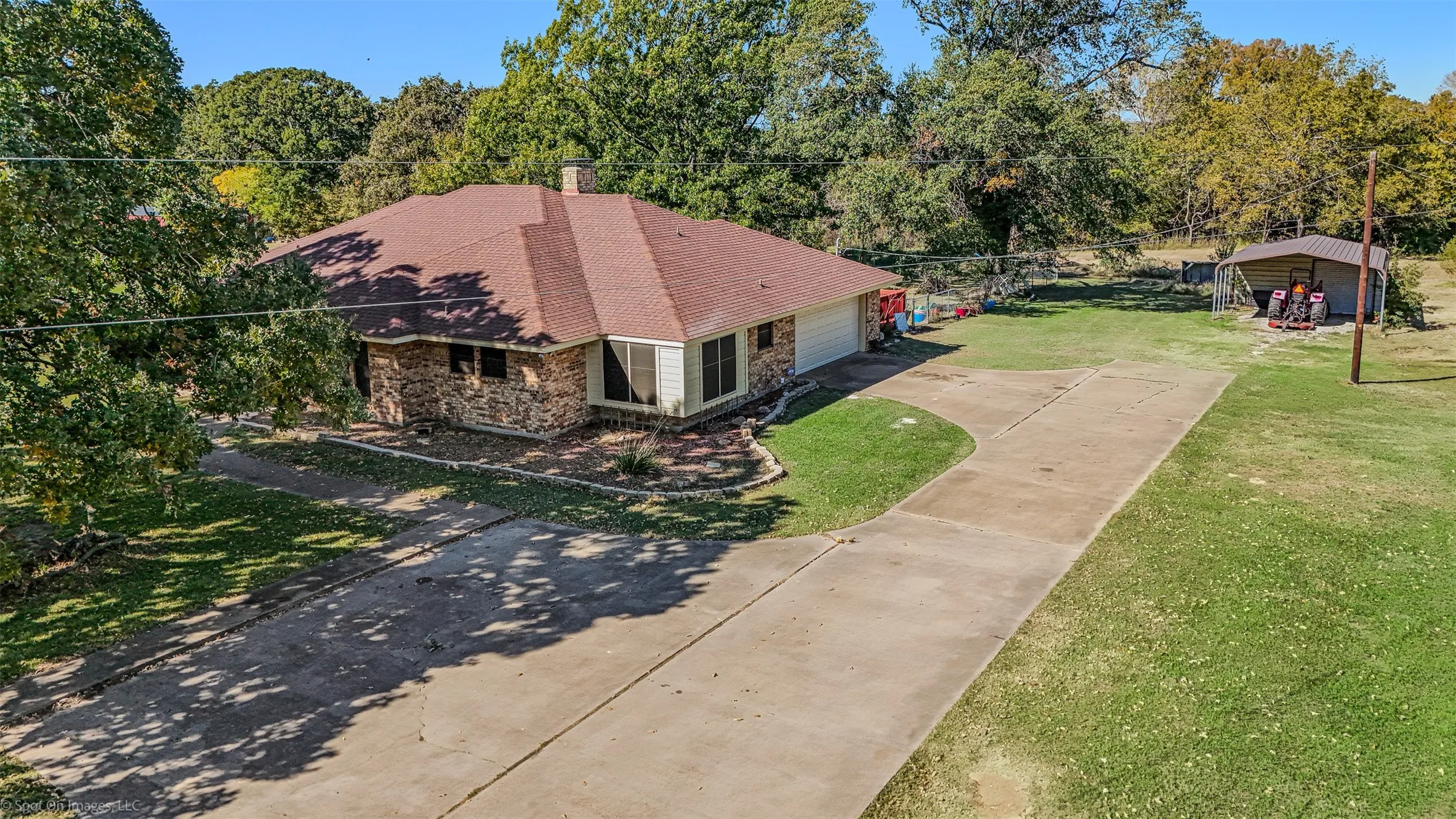 View from above of property featuring a tree filled landscape