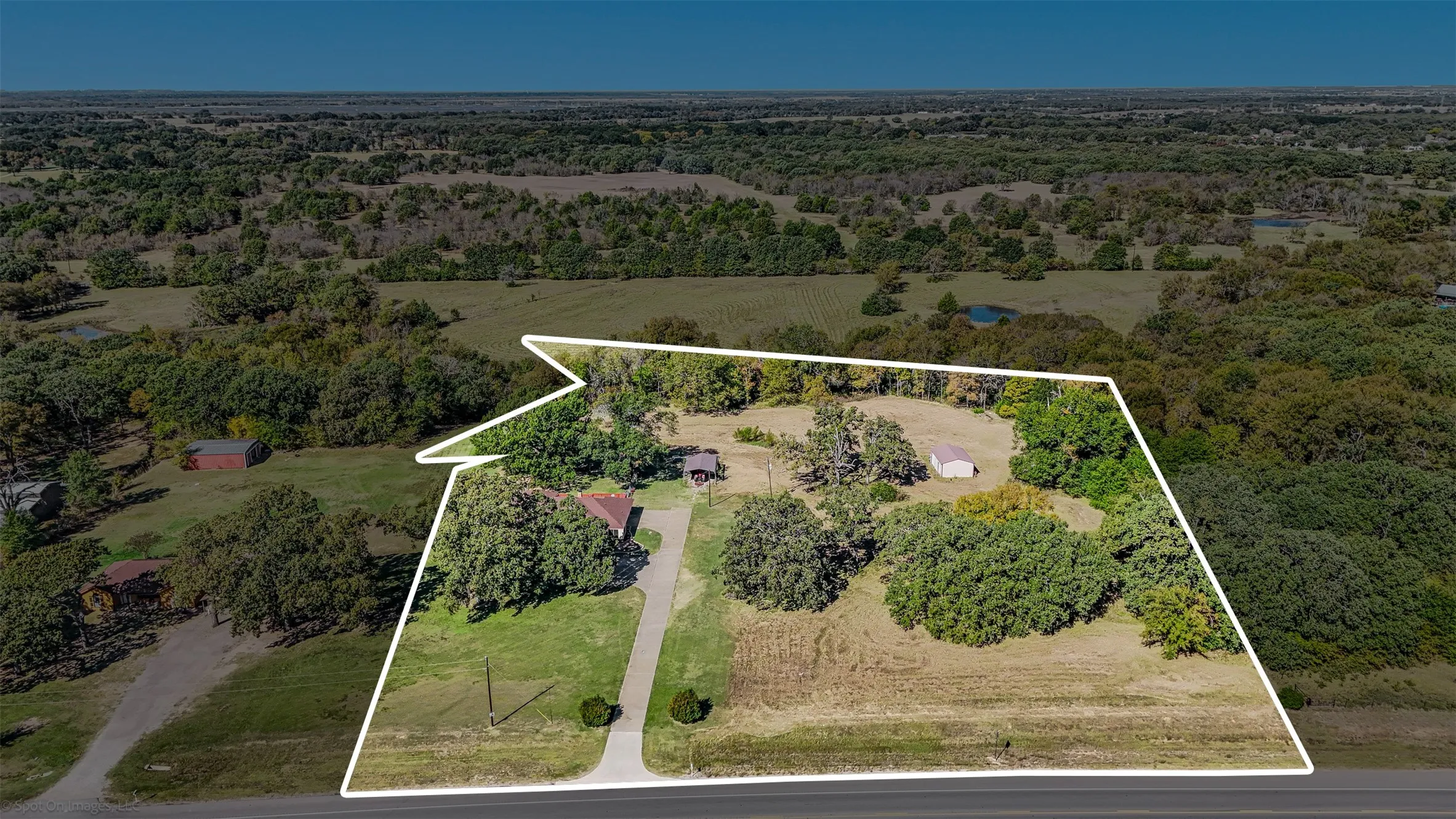 View of property location with property boundaries highlighted and a forest