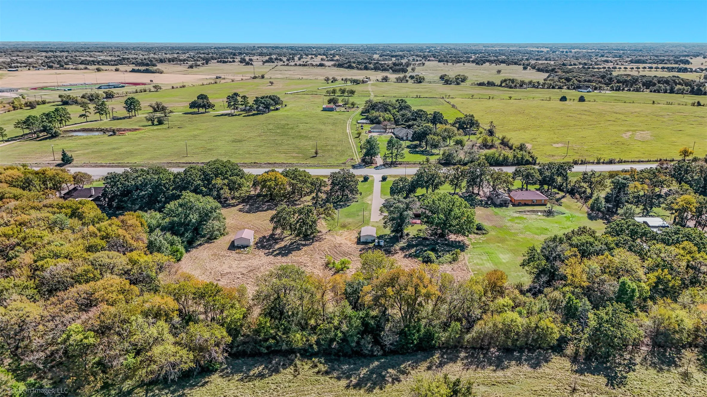 Aerial view of property's location featuring a tree filled landscape and rural landscape