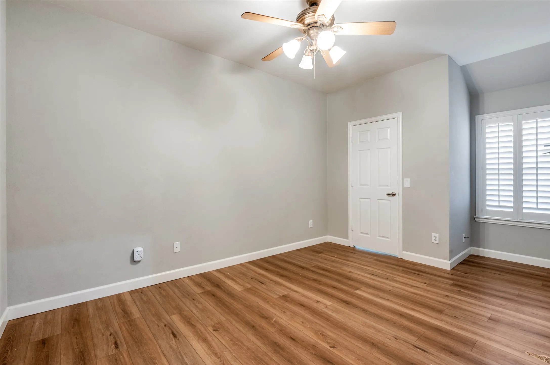 Guest Bedroom featuring ceiling fan and wood finished floors