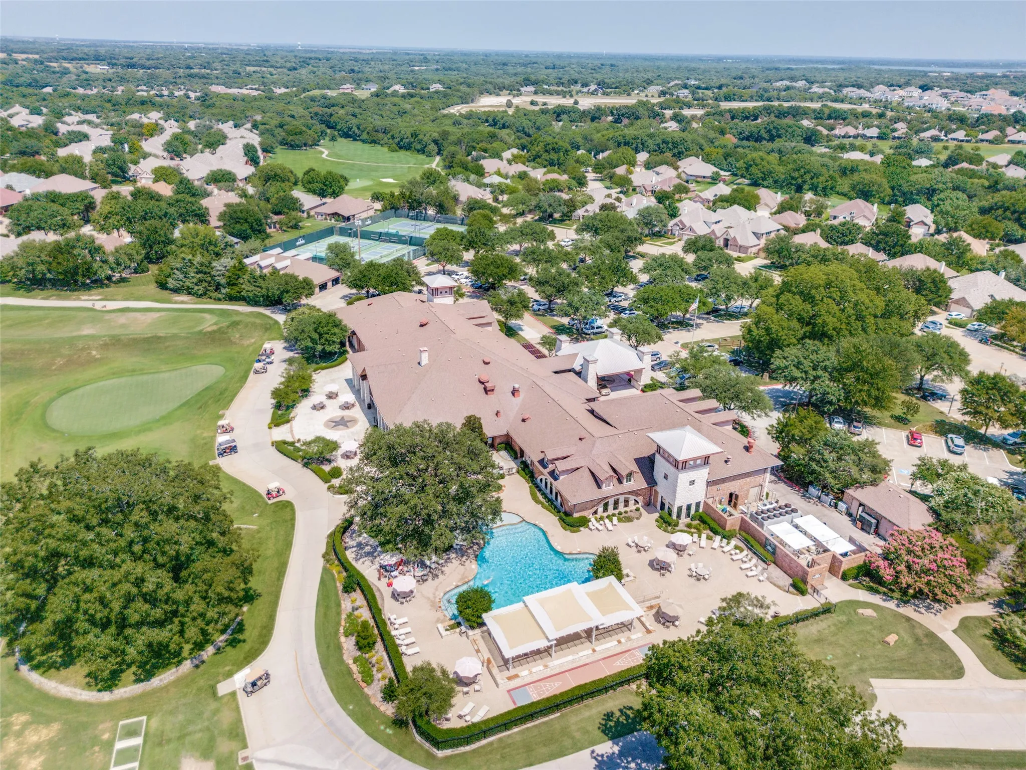 Aerial perspective of clubhouse area featuring a pool area, golf course and Pickle ball tennis court