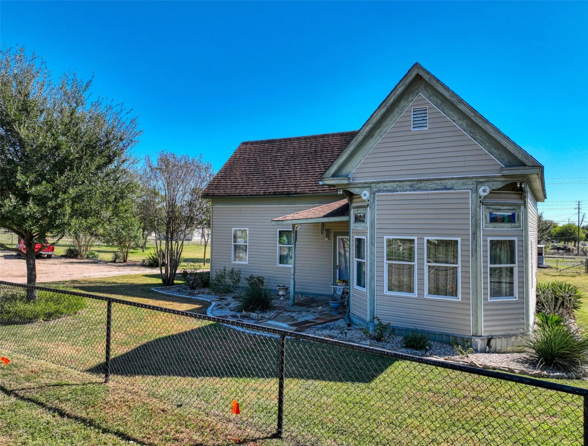 View of front of property with a shingled roof and a patio area