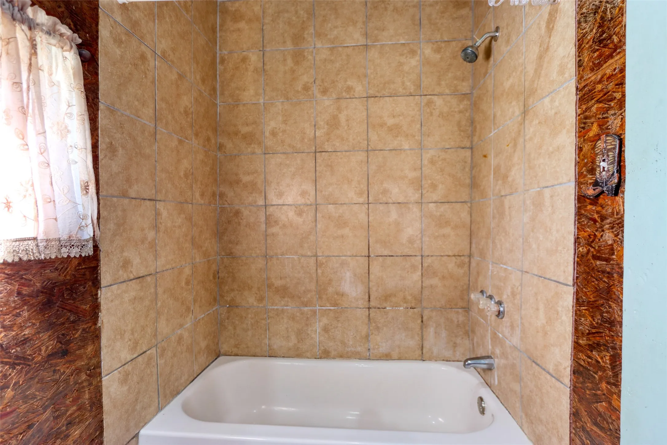 Bathroom featuring shower / tub combo with curtain