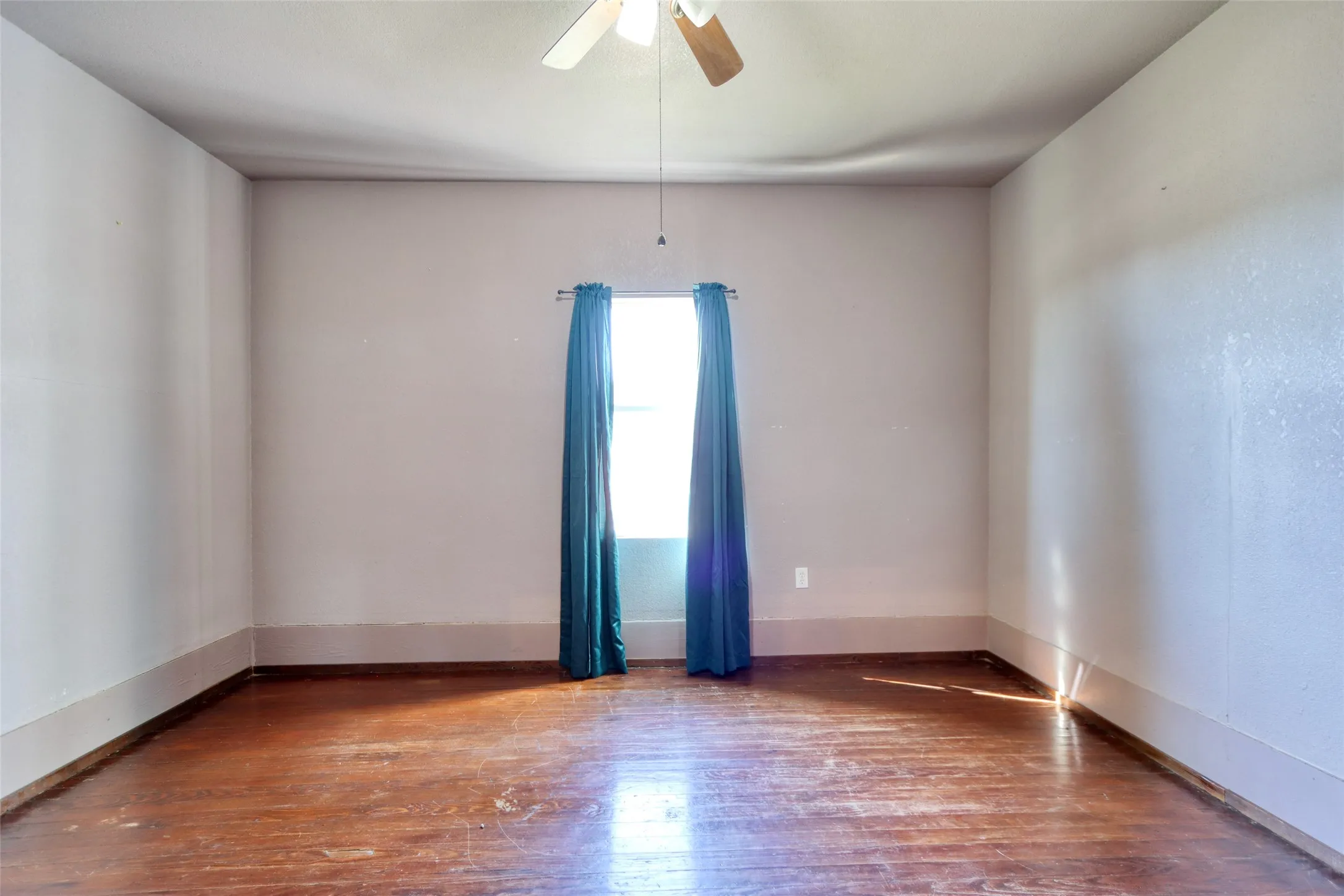 Bedroom 2 view with hardwood / wood-style flooring and ceiling fan