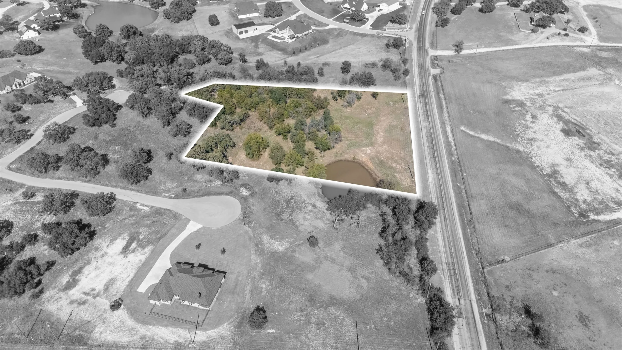 Aerial view of property and surrounding area featuring property parcel outlined