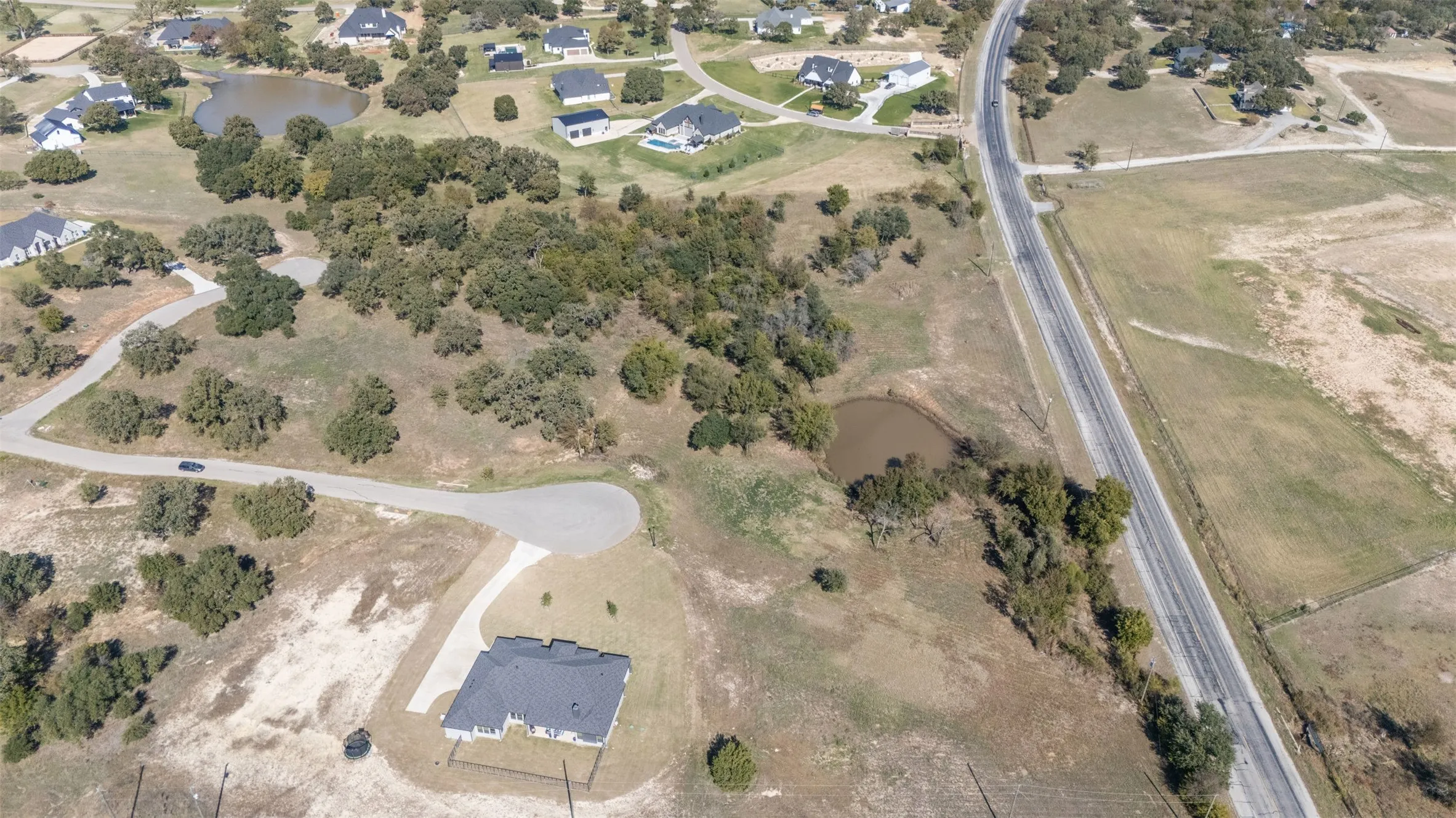 Aerial view of property's location featuring a large body of water