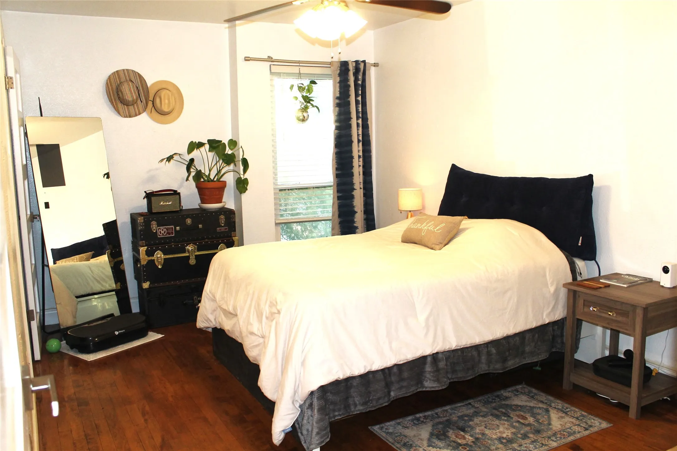 Bedroom with dark wood finished floors and a ceiling fan