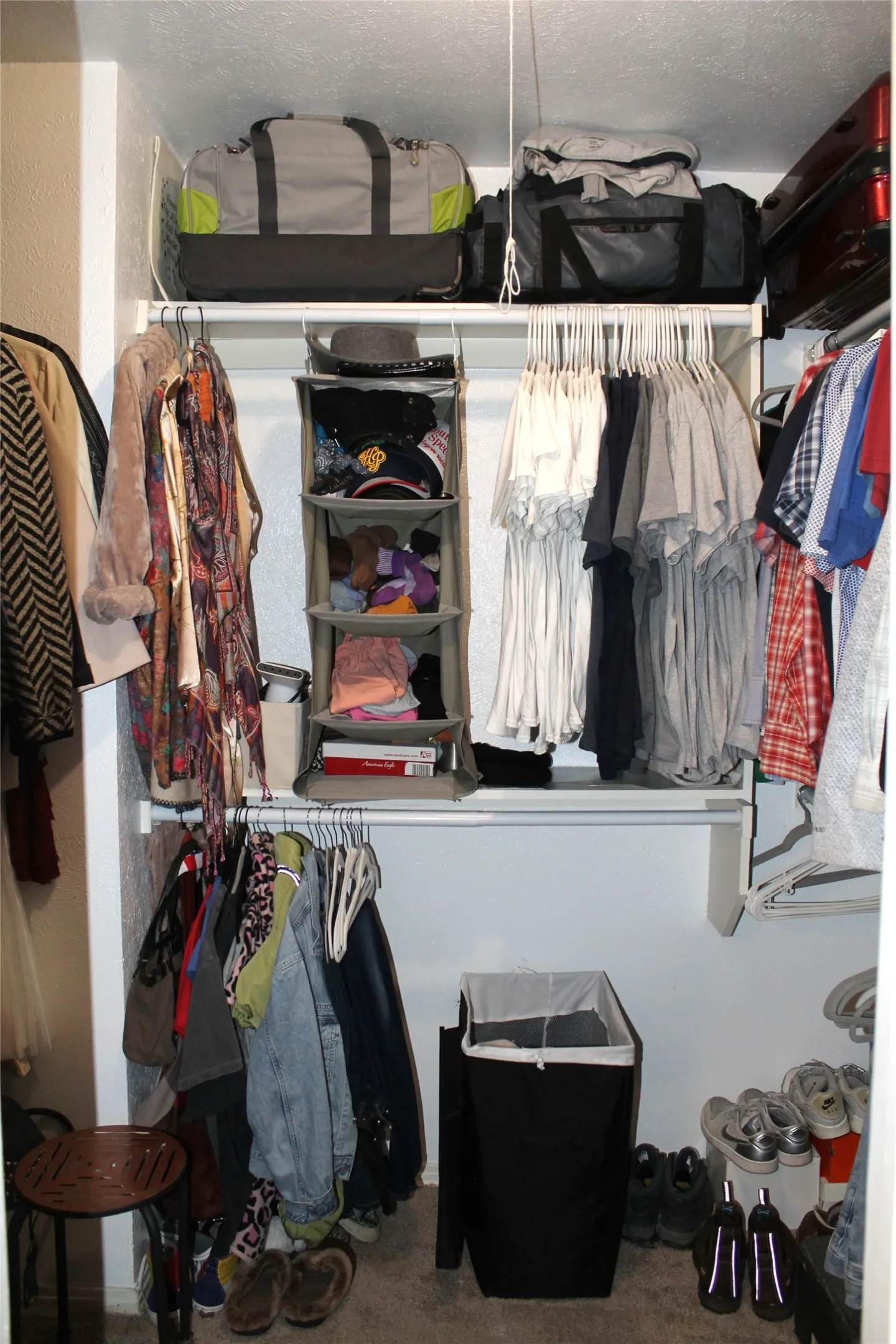 Walk in closet featuring dark carpet