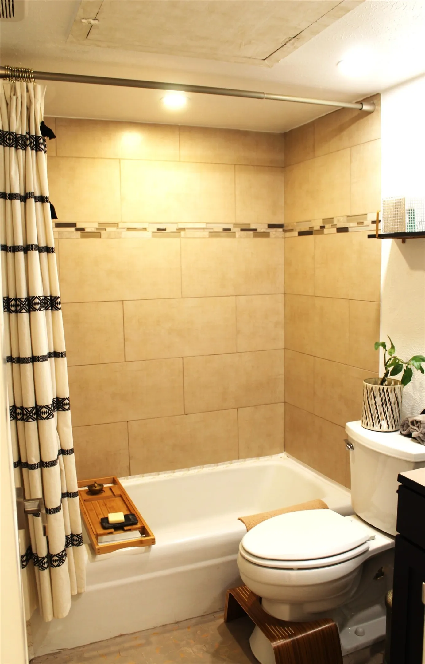 Bathroom with shower / bathtub combination with curtain and vanity