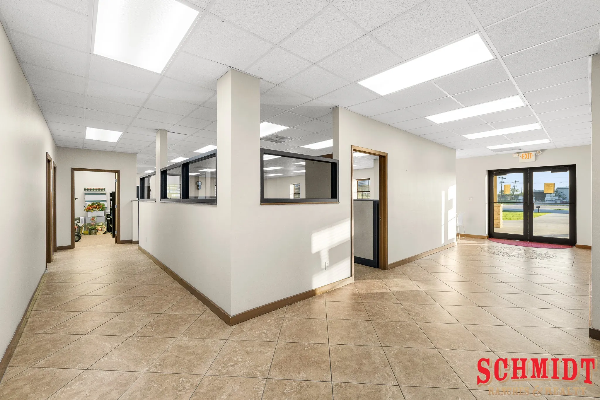 Recessed fluorescent lighting, commercial-grade tiled flooring, paneled interior doors, and interior transom windows