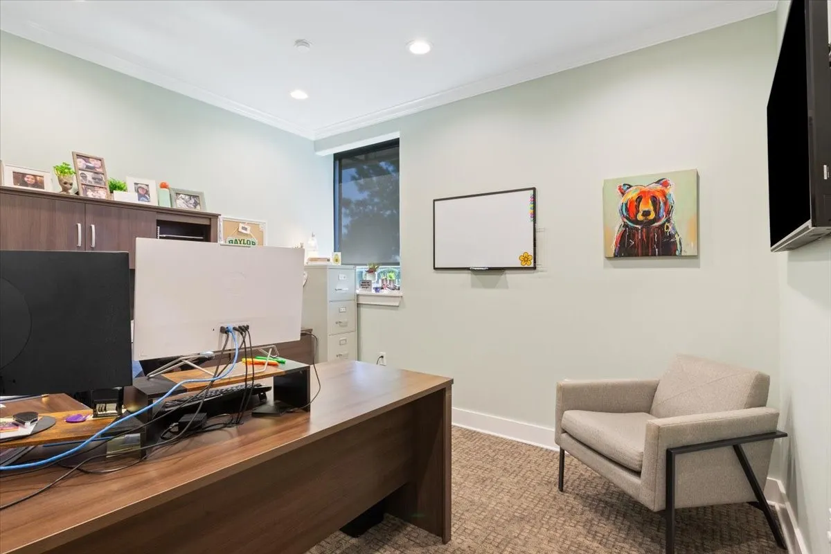 Office area with ornamental molding and recessed lighting