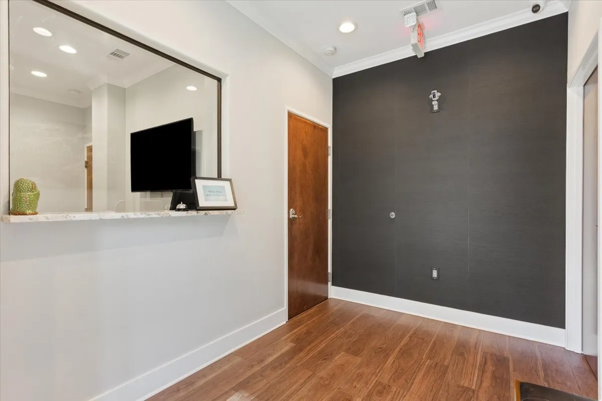 Unfurnished room with crown molding, recessed lighting, and wood finished floors