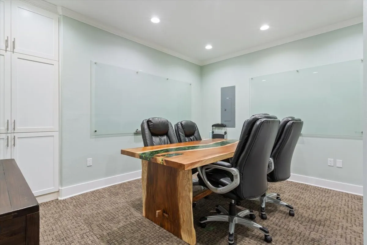 Office space featuring ornamental molding, electric panel, recessed lighting, and light carpet