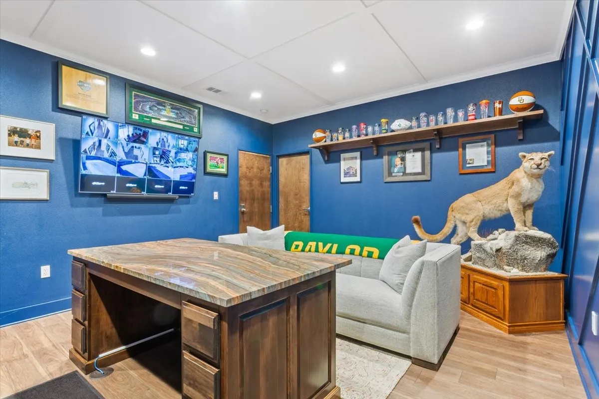 Office with light wood-type flooring and recessed lighting