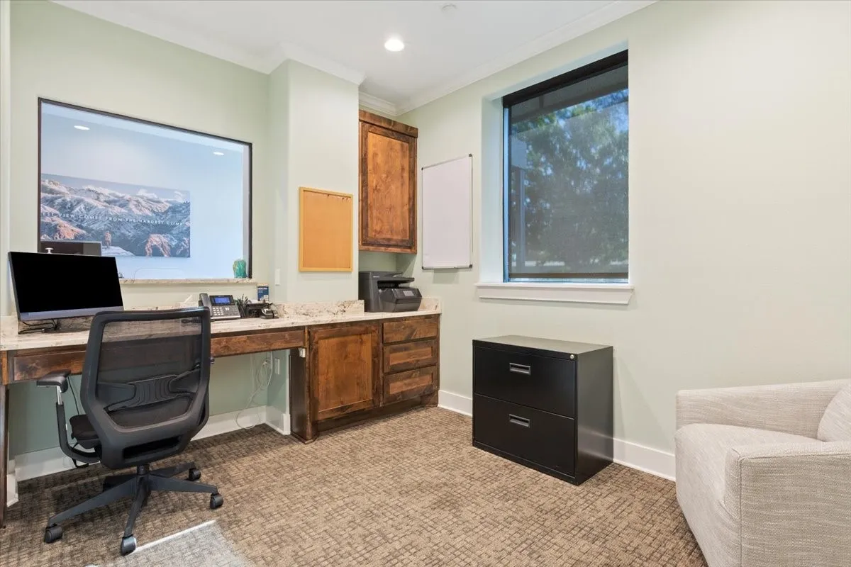 Home office with crown molding, light colored carpet, built in study area, and recessed lighting