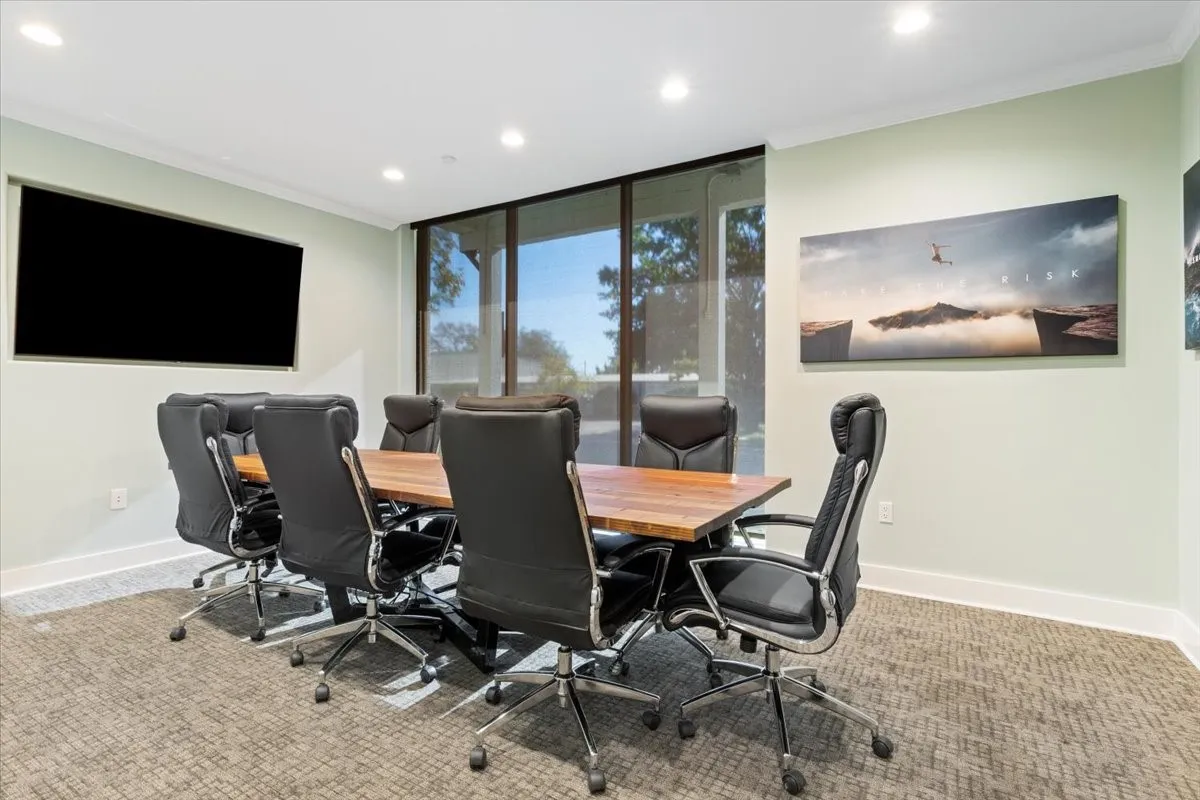 Office space with ornamental molding, expansive windows, recessed lighting, and carpet floors