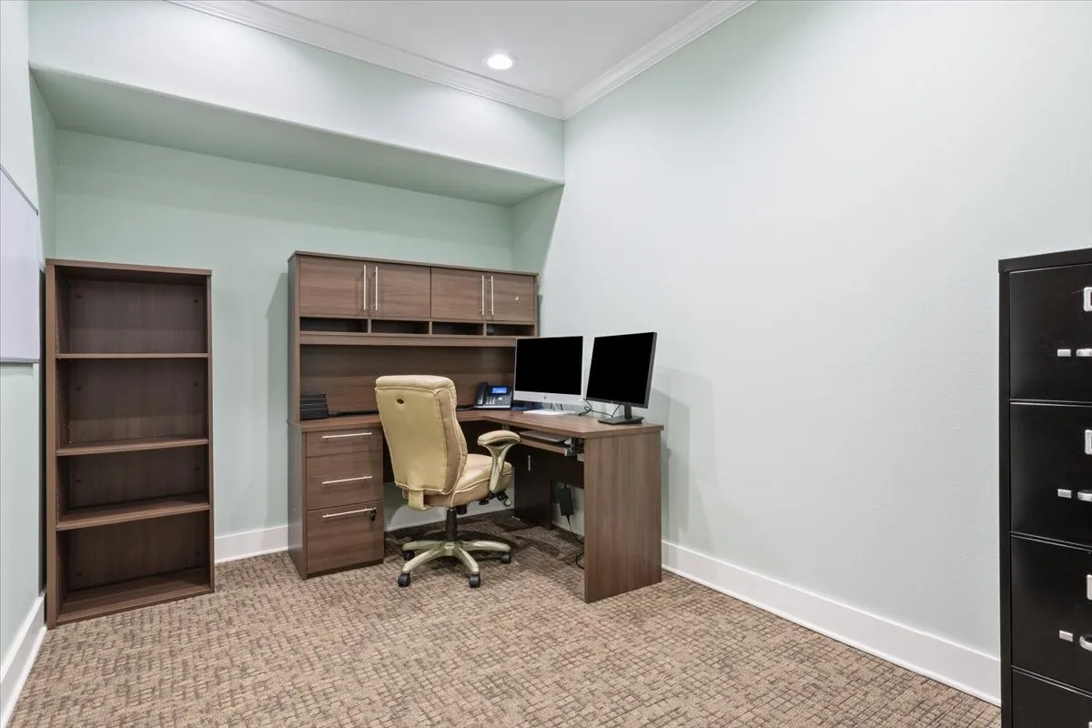 Home office with crown molding, light colored carpet, and recessed lighting