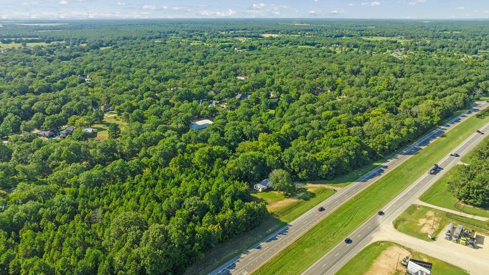 Aerial overview of property's location featuring a forest