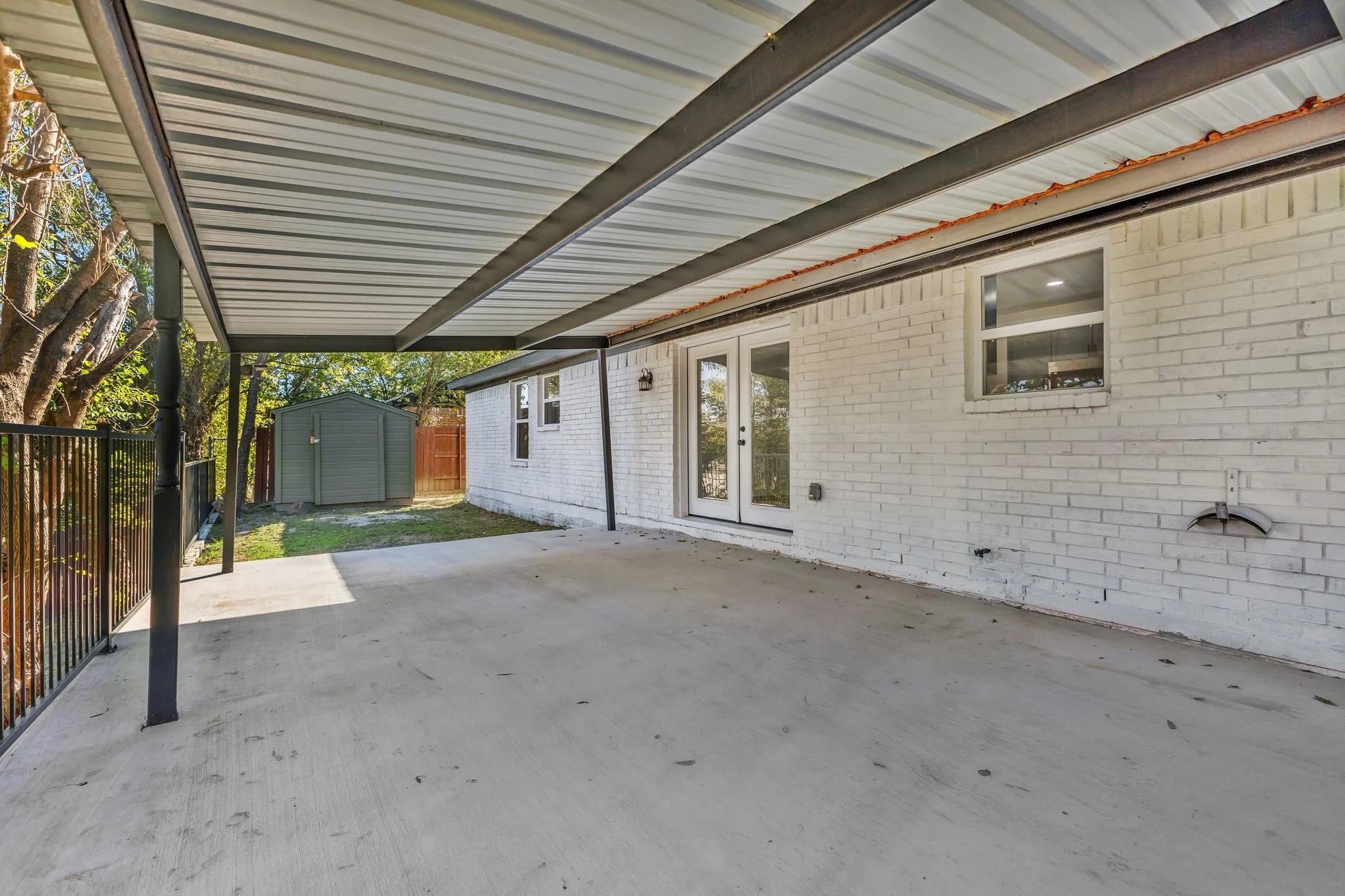View of patio featuring a shed and french doors
