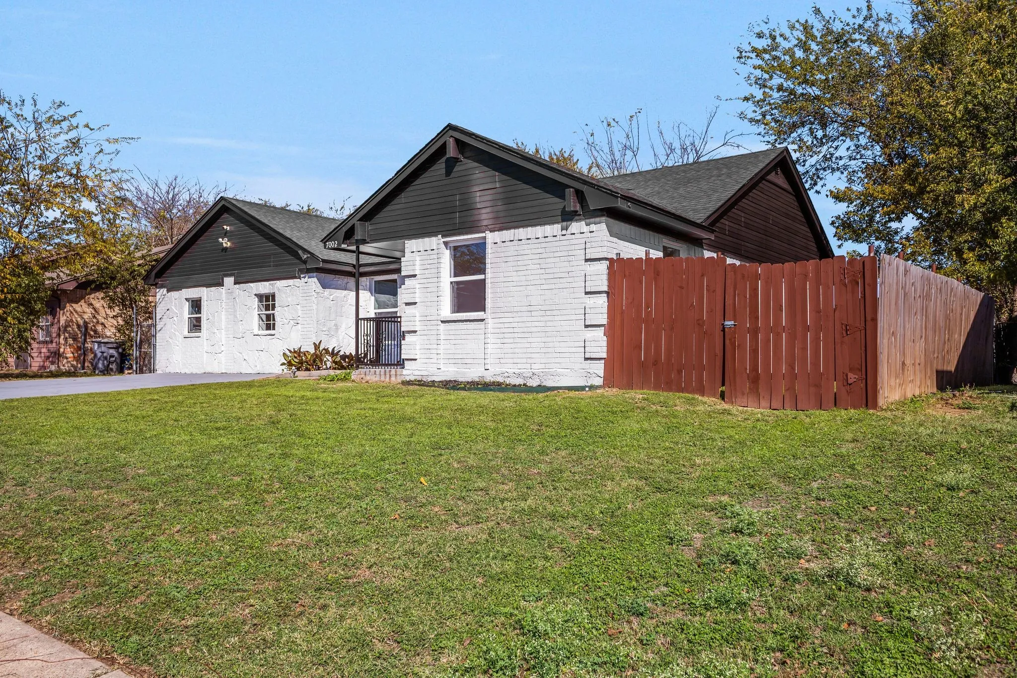 View of front facade with brick siding and roof with shingles