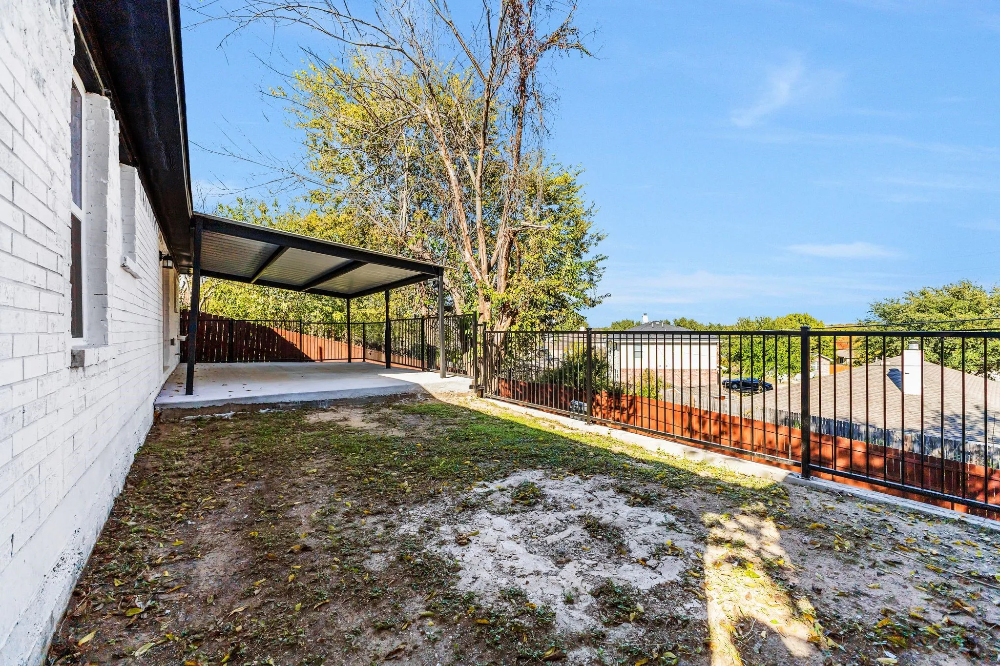 Fenced backyard with a patio