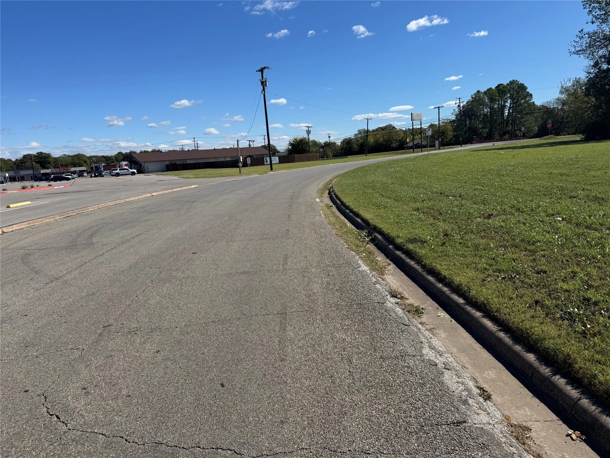 View of asphalt road with curbs