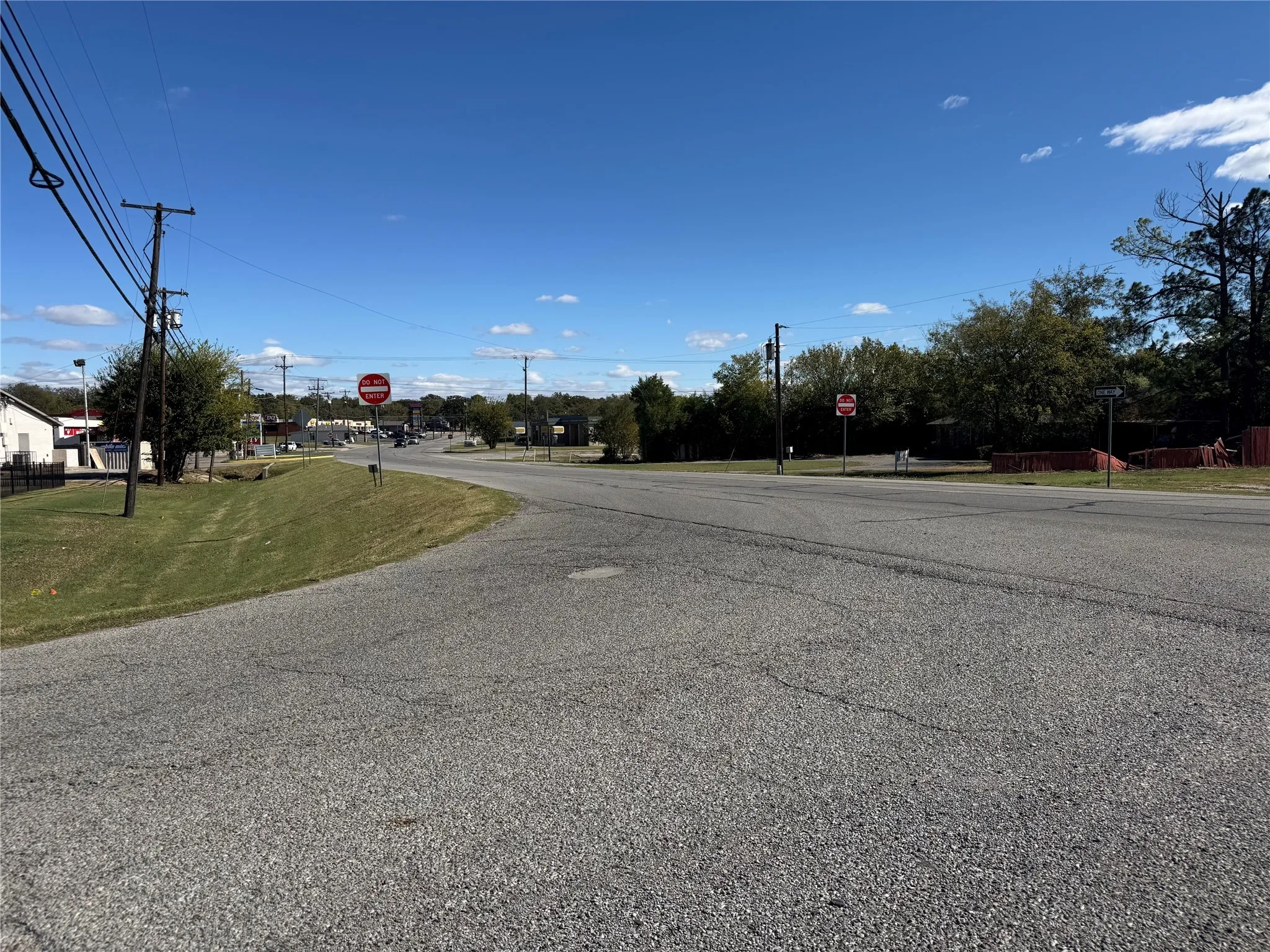 View of asphalt street with traffic signs