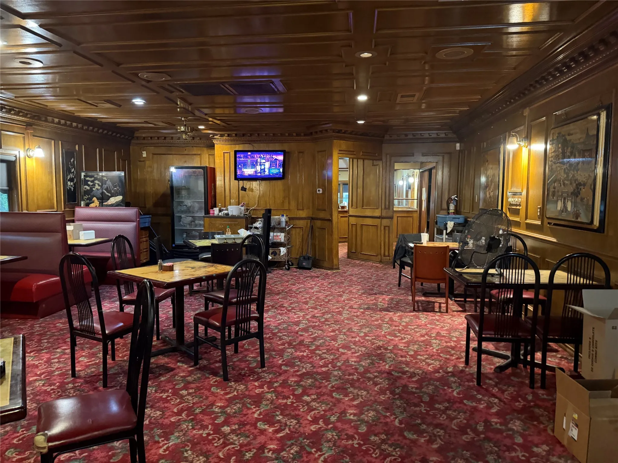 Dining room with wood walls, carpet flooring, and ornamental molding