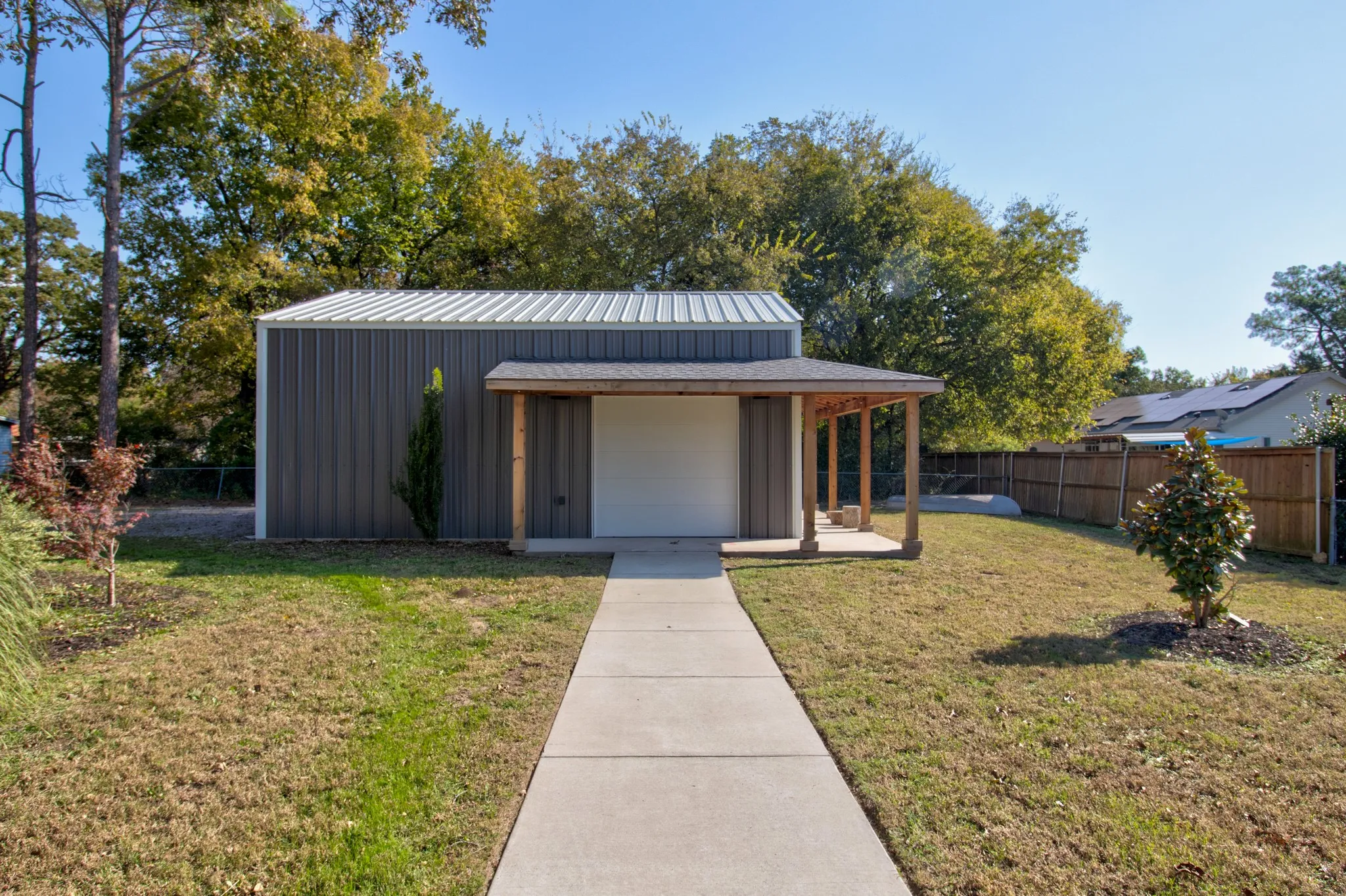 Custom Roof Overhang and concrete patio surrounding garage!