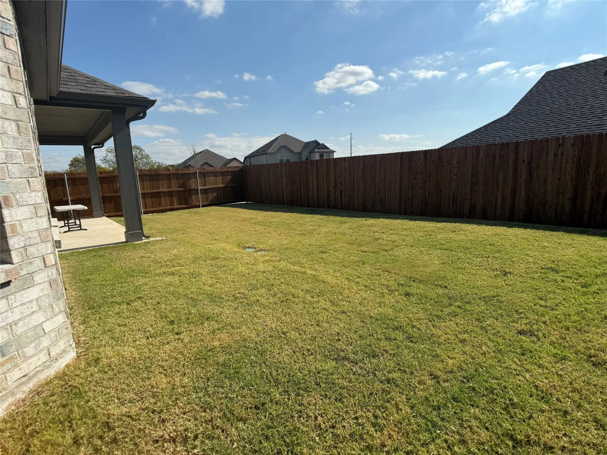 Fenced backyard featuring a patio