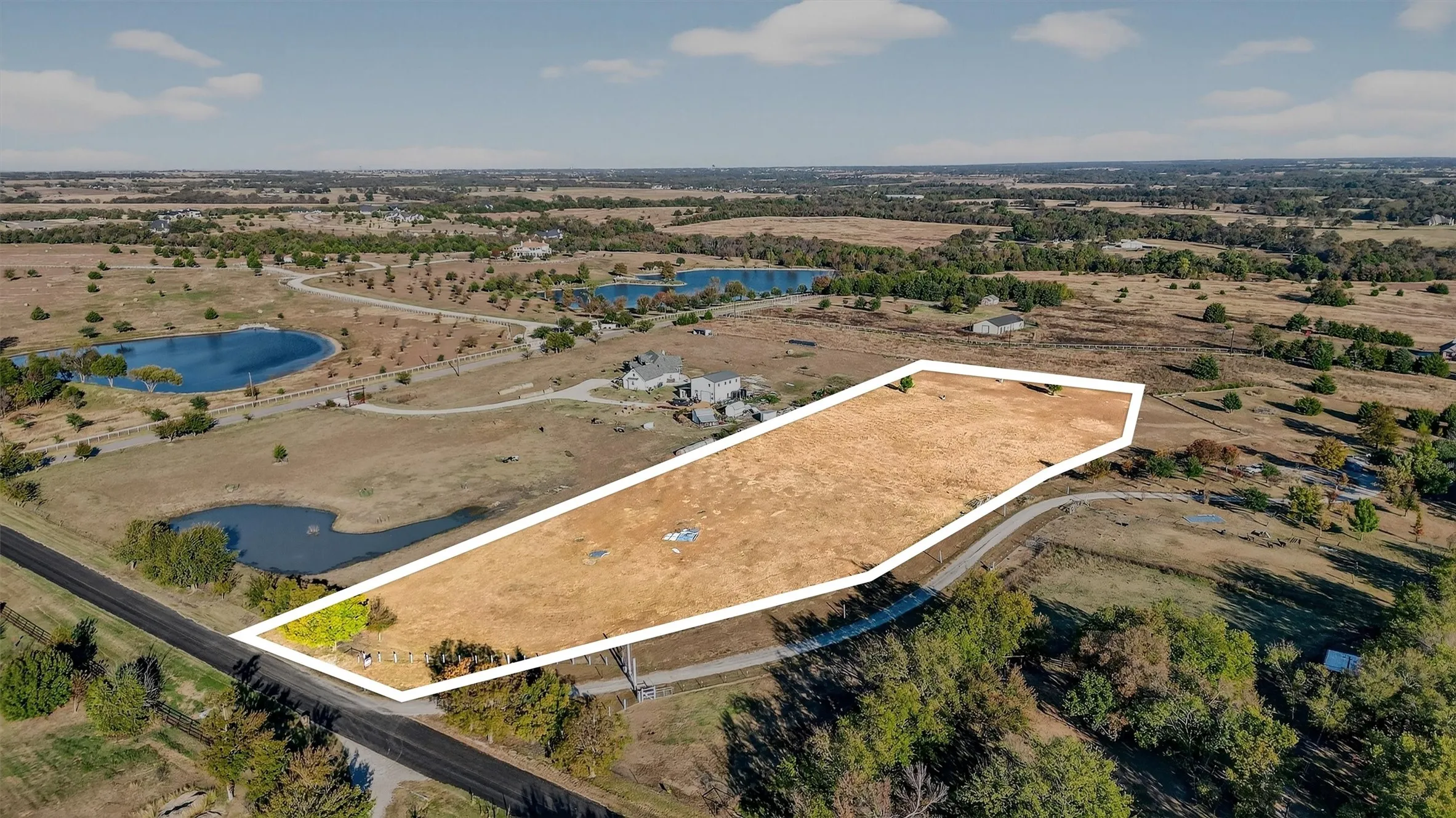 Overview of rural landscape with property boundaries highlighted and a large body of water