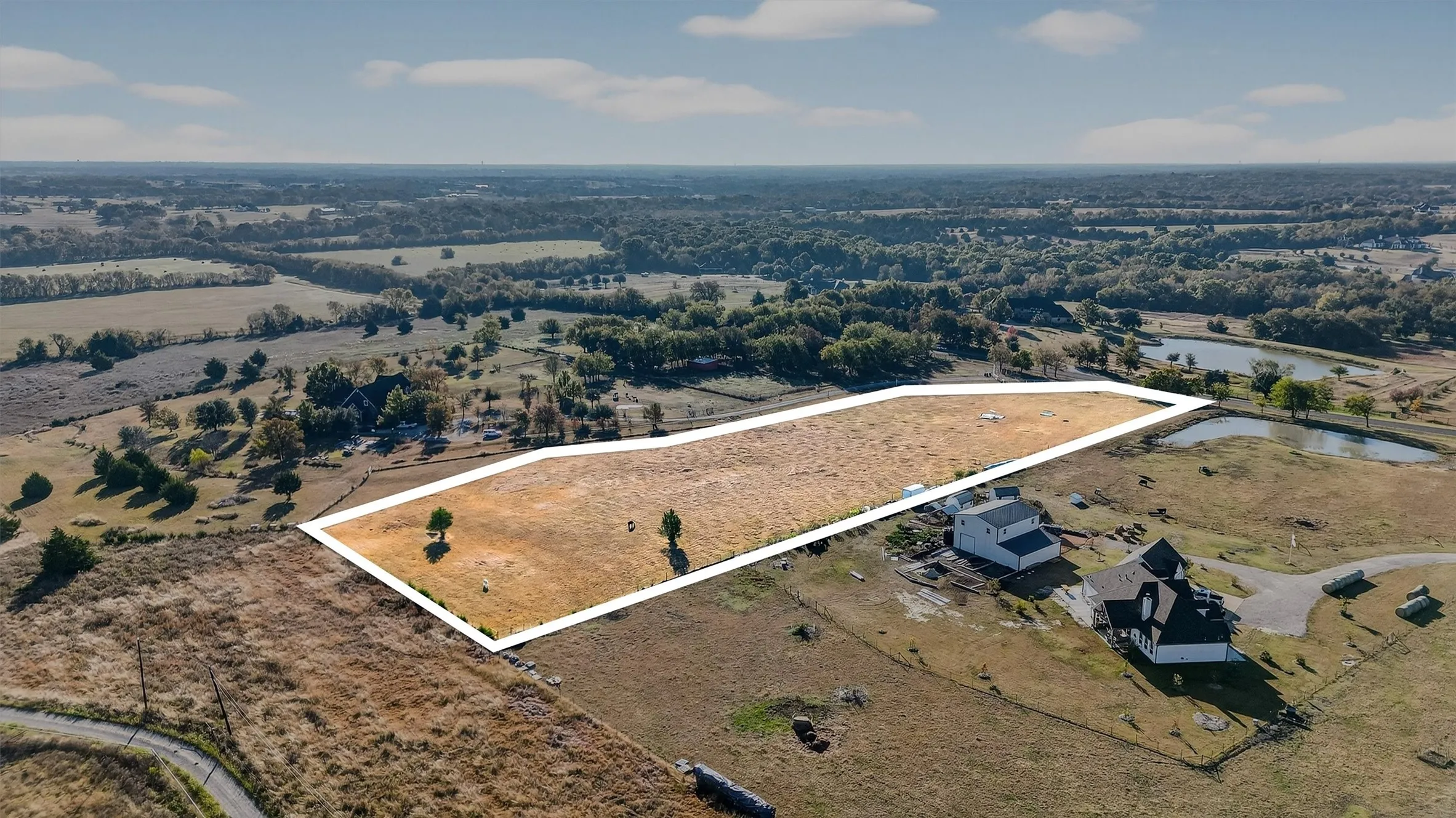 Aerial view of property and surrounding area with property boundaries highlighted