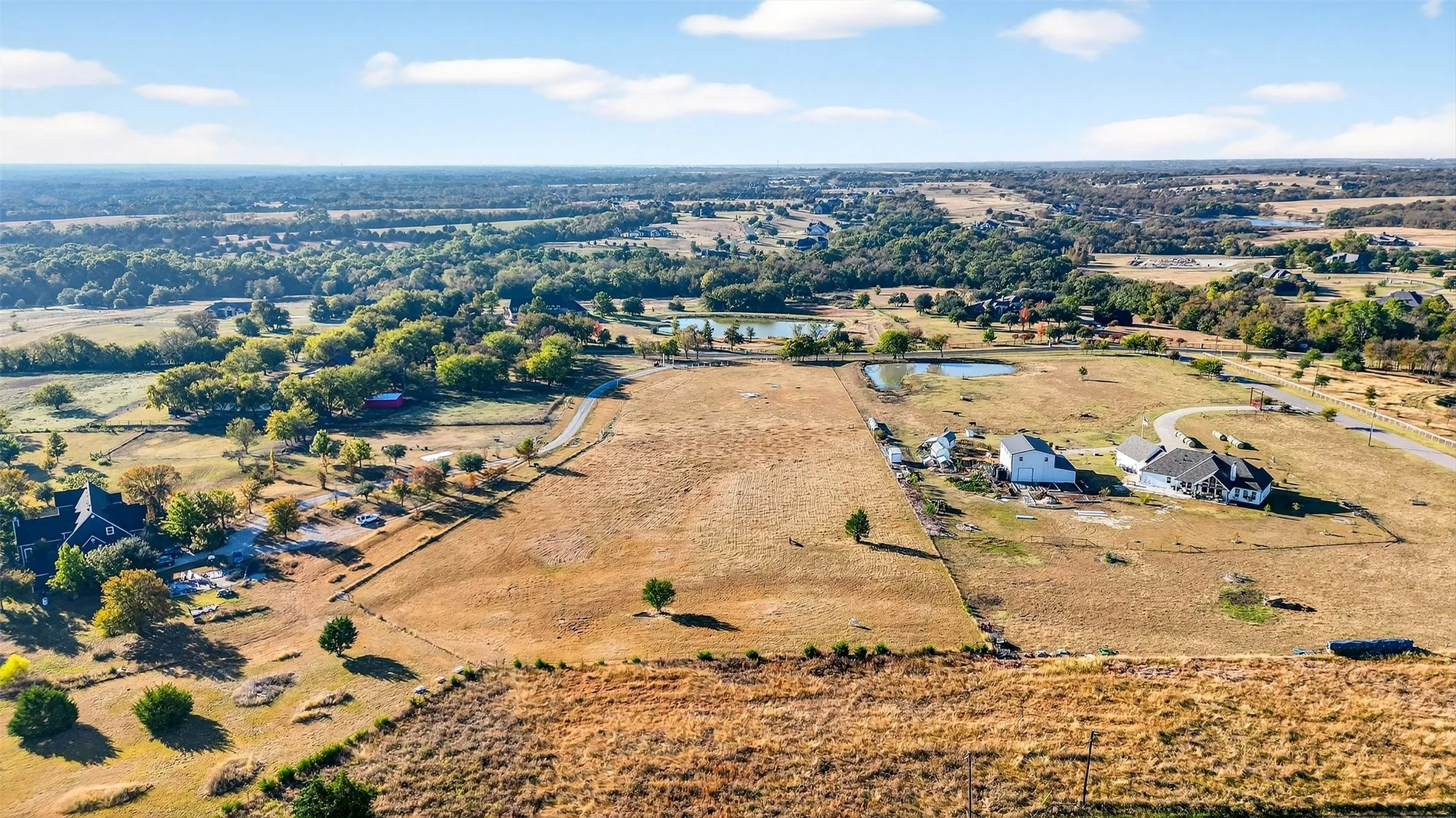 Aerial view of sparsely populated area featuring a nearby body of water