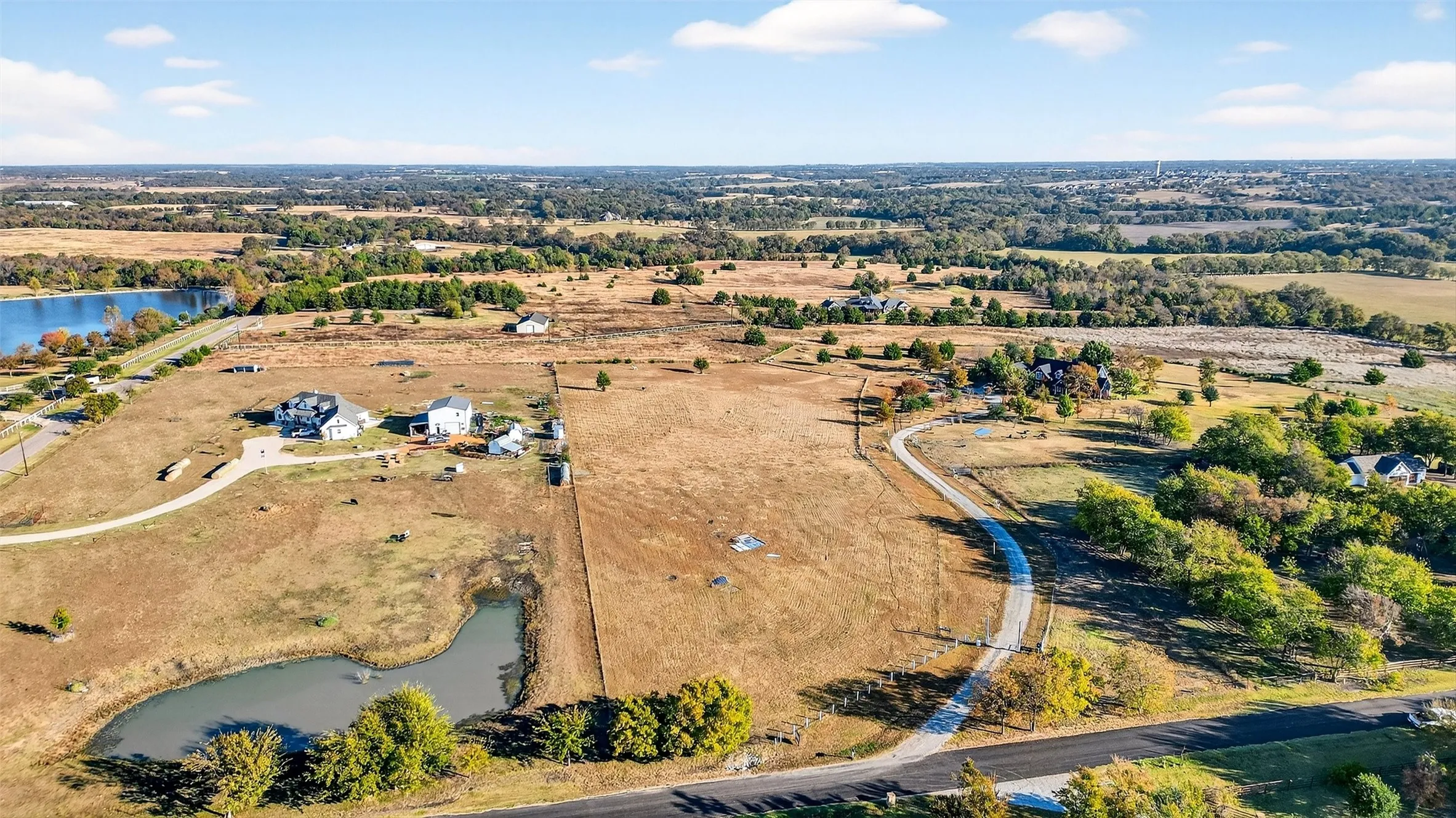 Aerial view of property's location with a nearby body of water and rural landscape