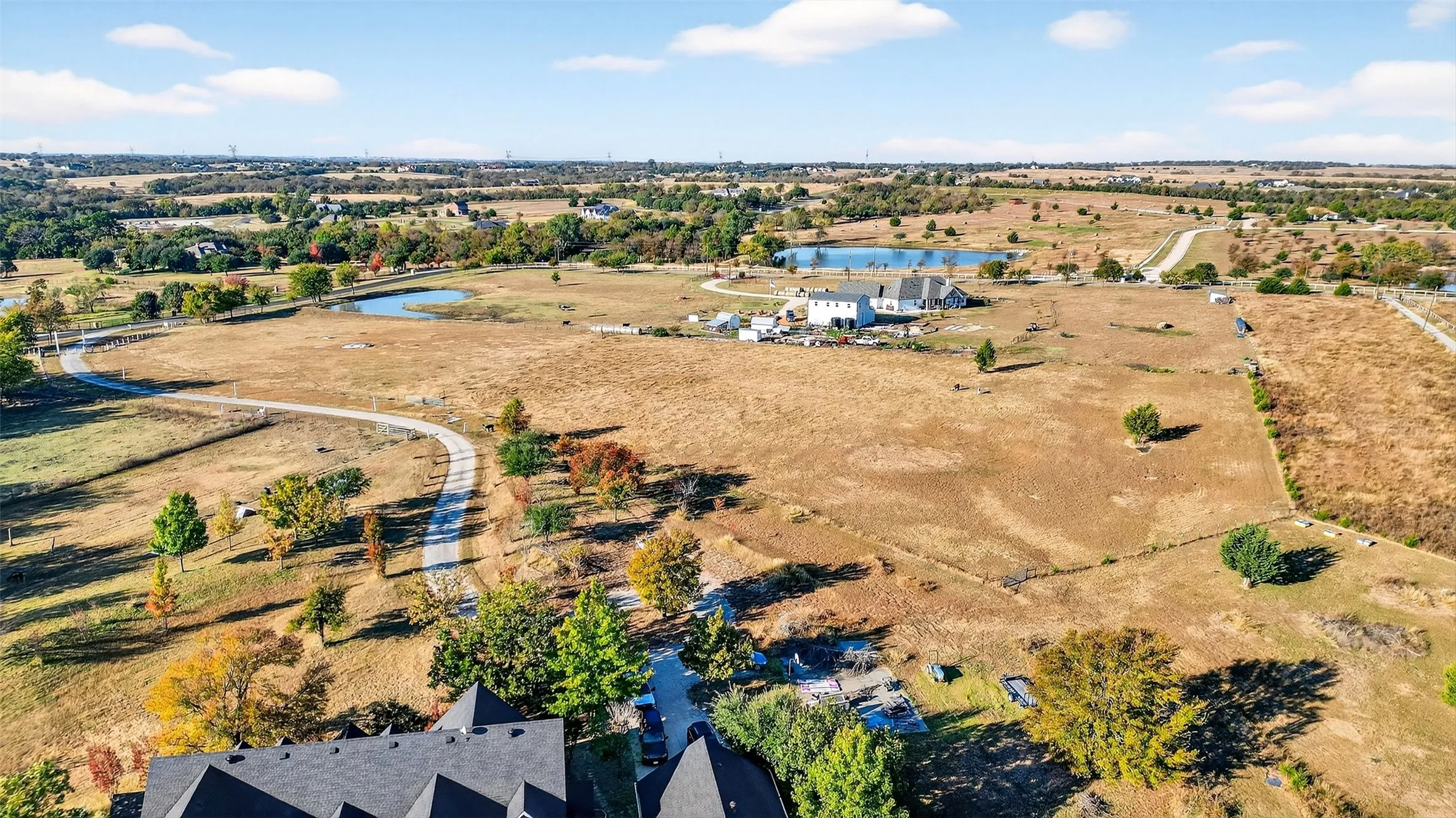 Aerial overview of property's location with a large body of water and rural landscape