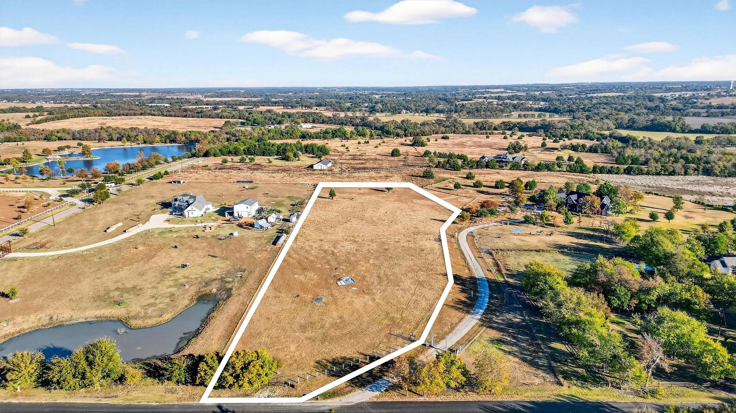 Overview of rural landscape featuring a large body of water and property boundaries highlighted