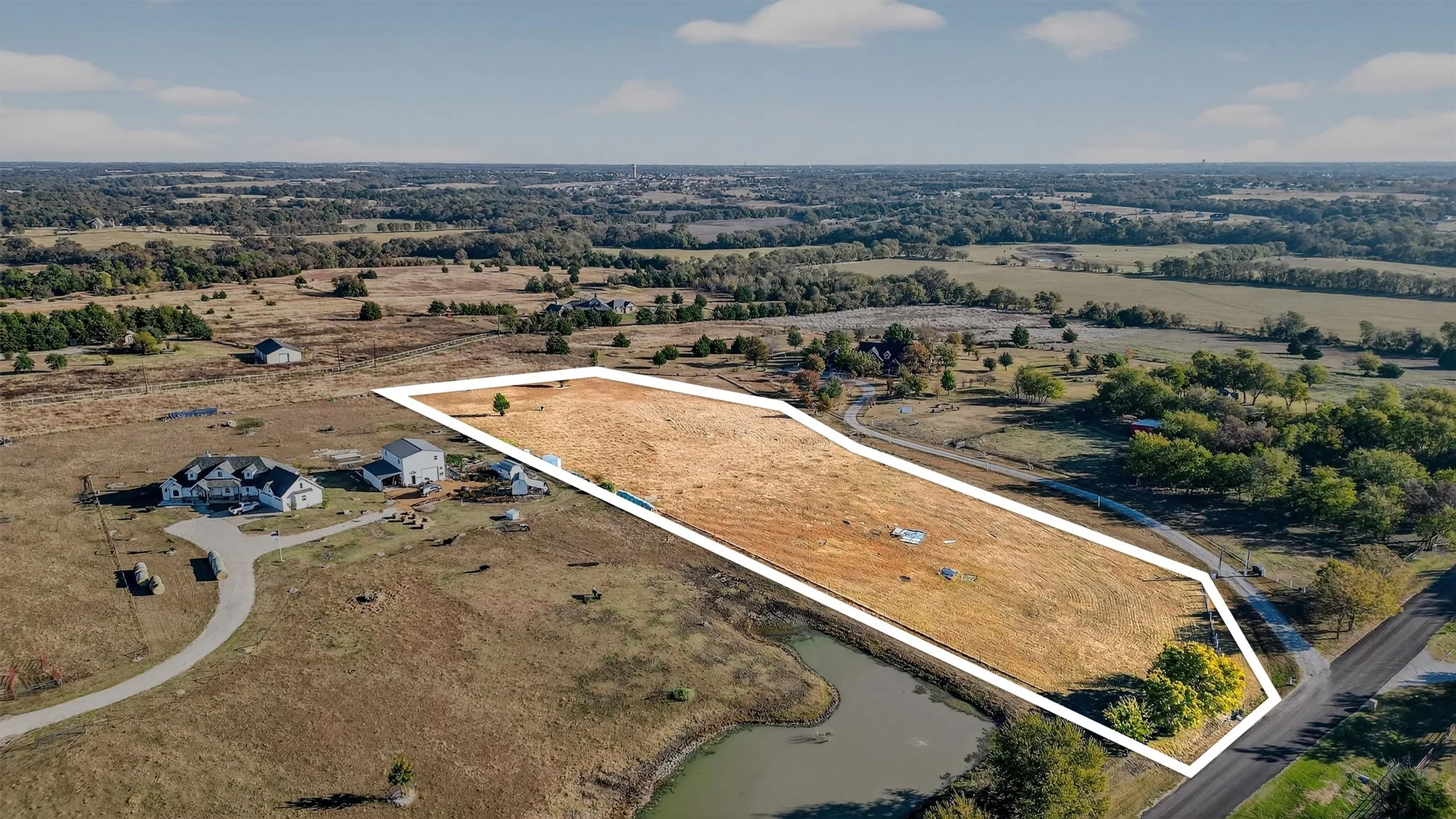 Aerial view of sparsely populated area featuring property boundaries highlighted