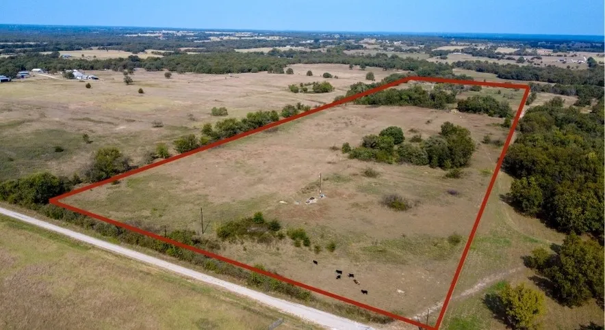 Aerial view of sparsely populated area with property parcel outlined