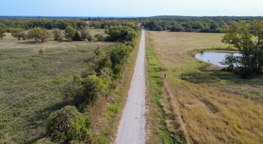 Aerial view of sparsely populated area featuring a nearby body of water