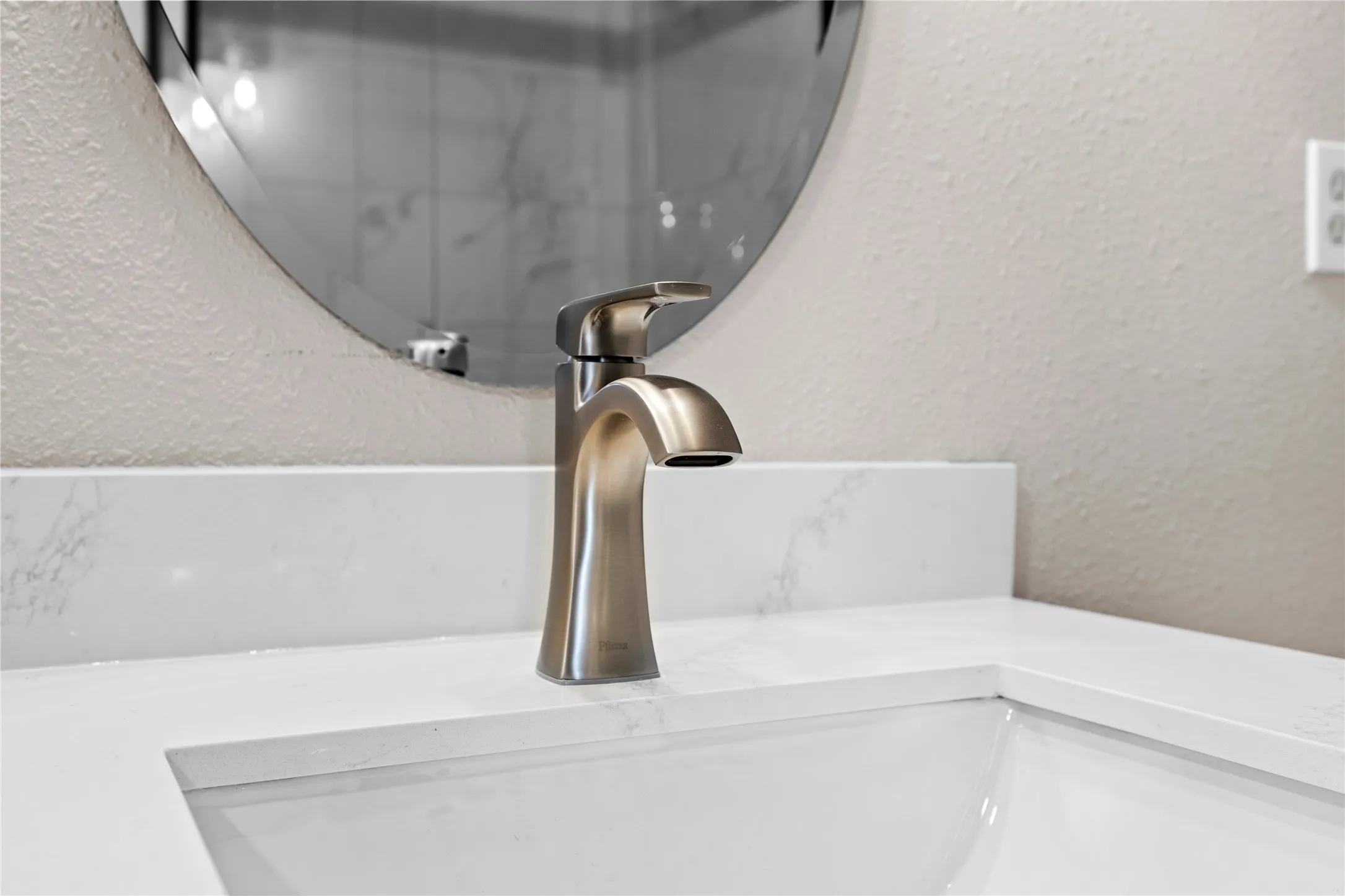 Bathroom view of a textured wall and vanity