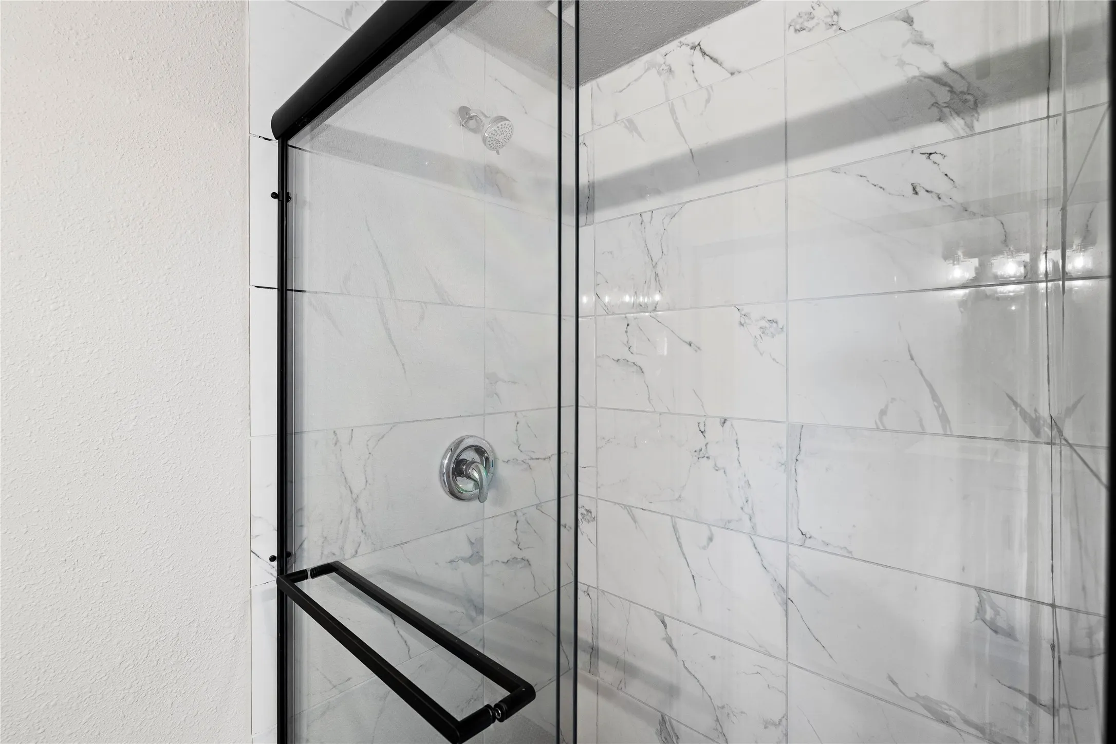 Bathroom featuring a marble finish shower