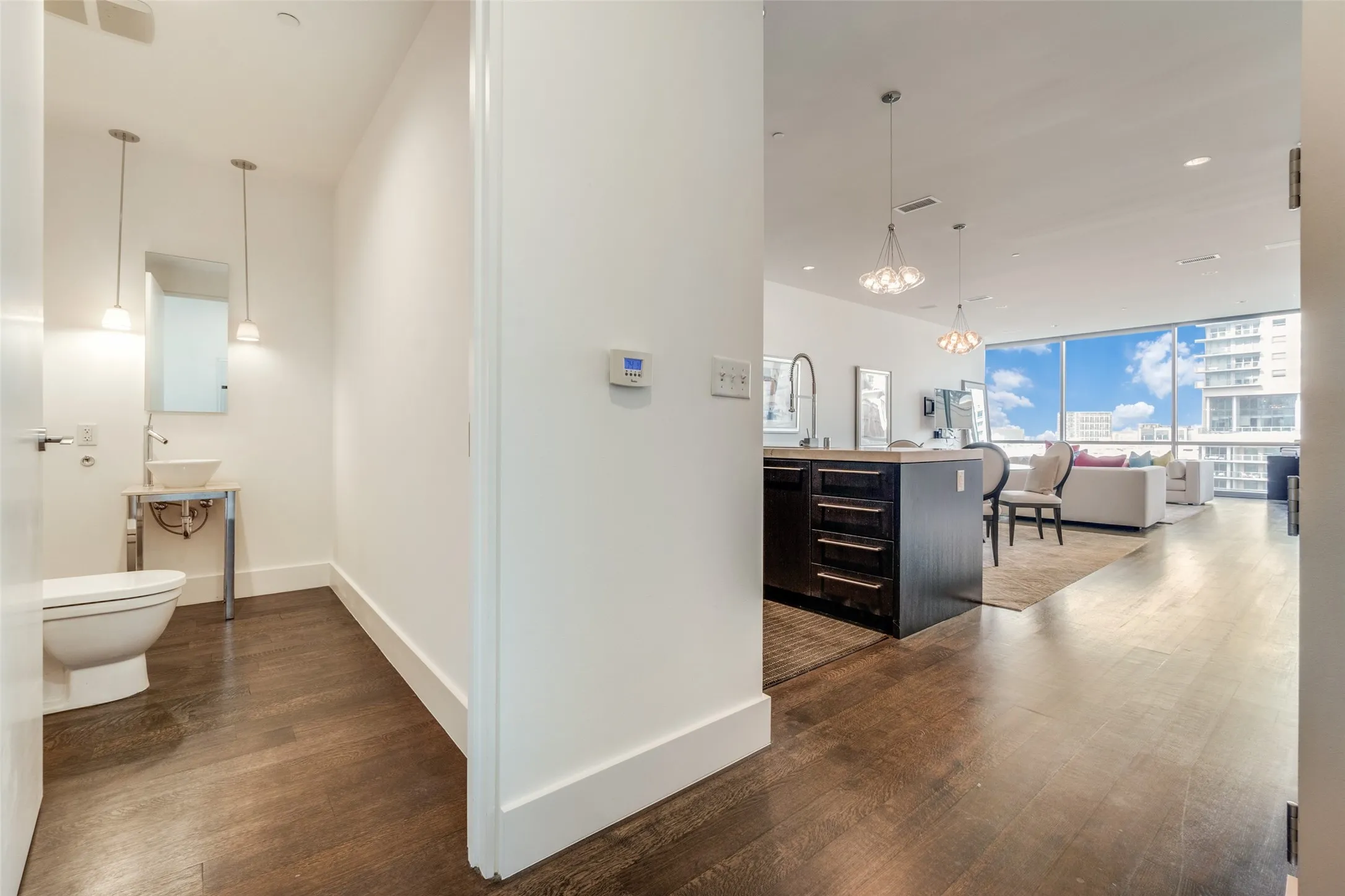 Hallway with expansive windows, dark wood-type flooring, recessed lighting, and a chandelier