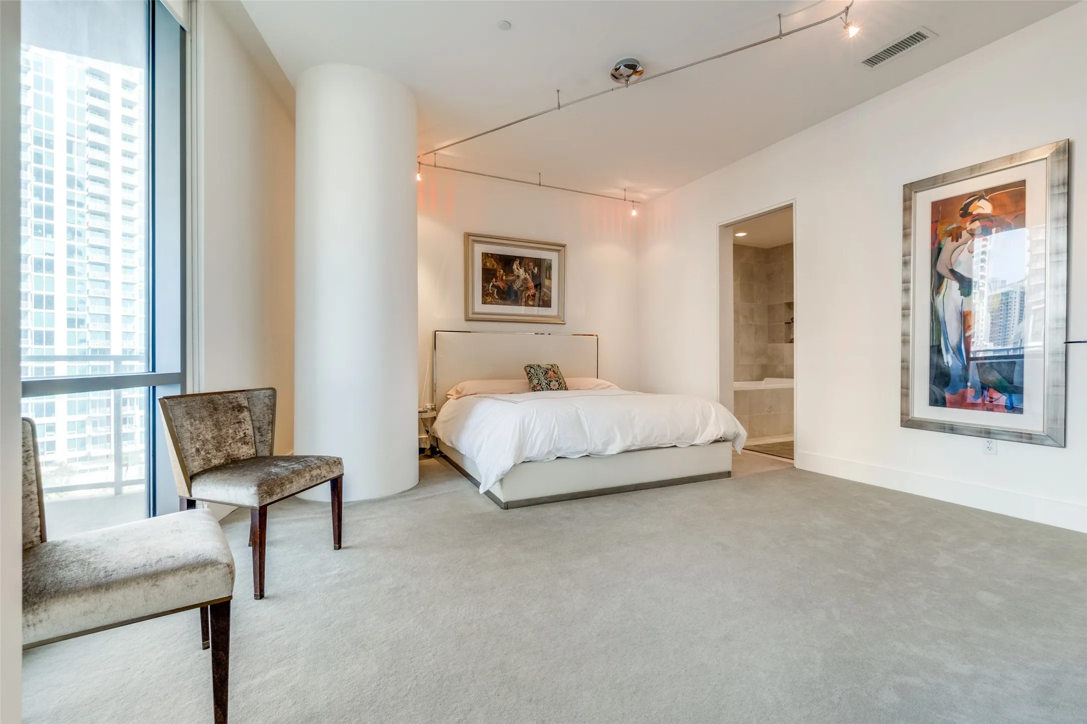 Bedroom with multiple windows and carpet floors
