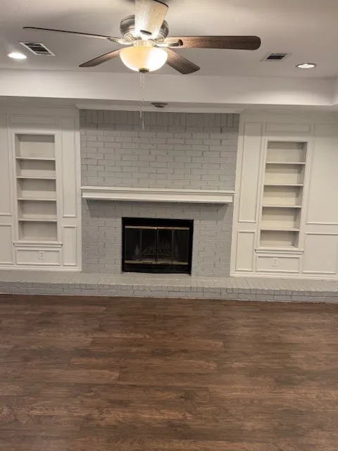 Detailed view of built in features, recessed lighting, ceiling fan, wood finished floors, and a fireplace