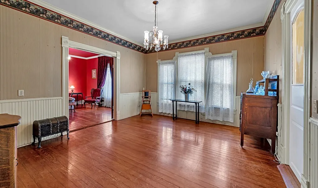 Dining area featuring hardwood / wood-style floors, ornamental molding, and a chandelier